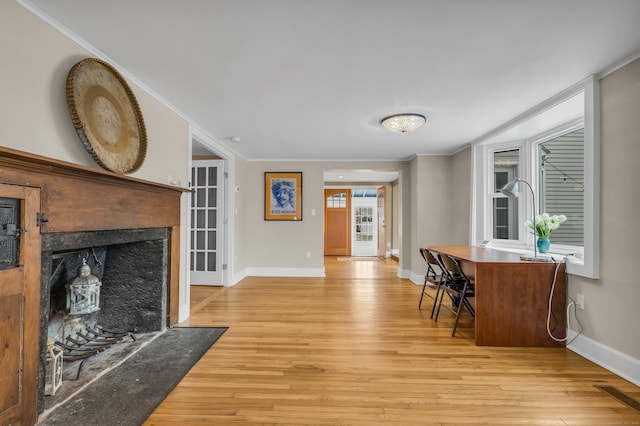 387 N River St, Guilford, CT 06437 - living area featuring light wood-type flooring, baseboards, crown molding, and a fireplace