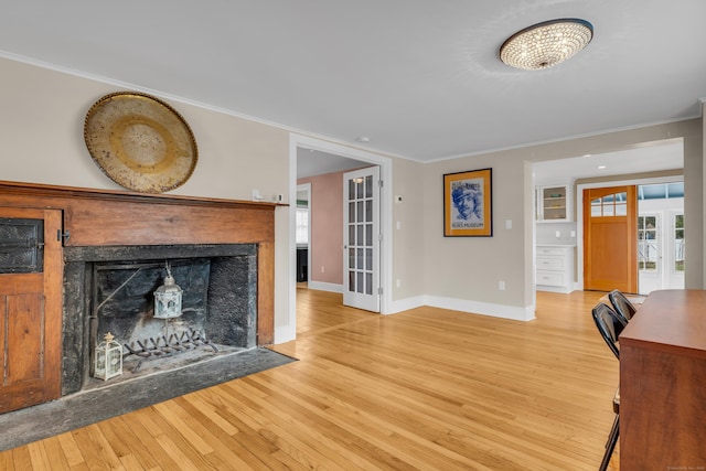 387 N River St, Guilford, CT 06437 - living area with light wood finished floors, ornamental molding, baseboards, and french doors