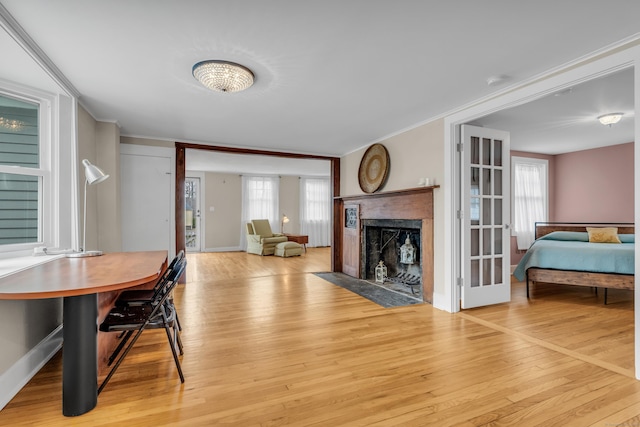 387 N River St, Guilford, CT 06437 - dining space with crown molding, light wood finished floors, plenty of natural light, and a fireplace with flush hearth
