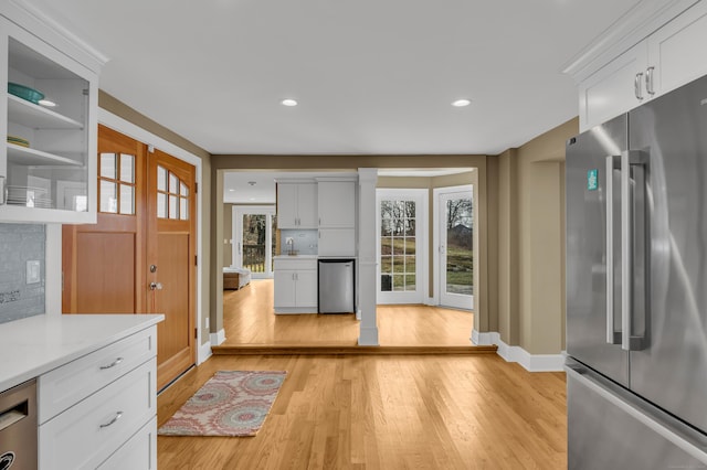 387 N River St, Guilford, CT 06437 - kitchen featuring stainless steel appliances, light wood-type flooring, light countertops, white cabinetry, and baseboards