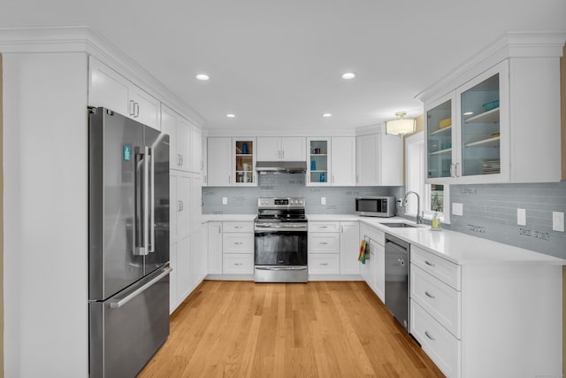 387 N River St, Guilford, CT 06437 - kitchen with appliances with stainless steel finishes, a sink, light countertops, light wood-style flooring, and tasteful backsplash