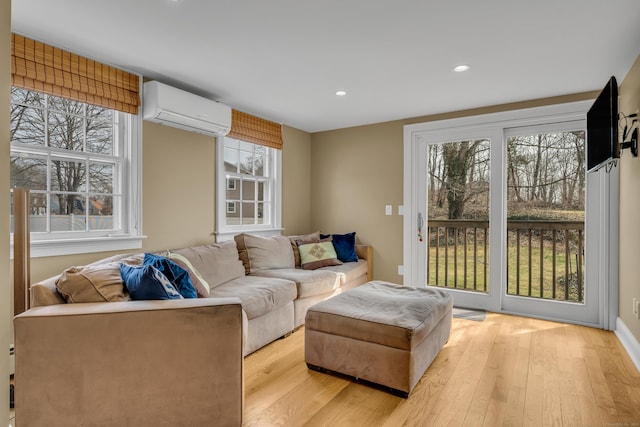 387 N River St, Guilford, CT 06437 - living area featuring an AC wall unit, light wood finished floors, and recessed lighting