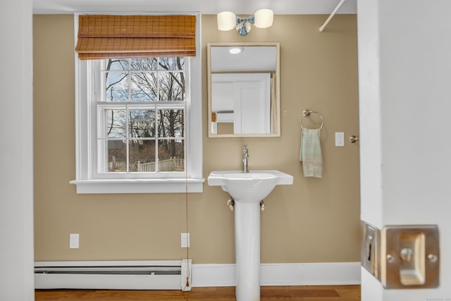 387 N River St, Guilford, CT 06437 - bathroom featuring a baseboard heating unit, baseboards, and wood finished floors