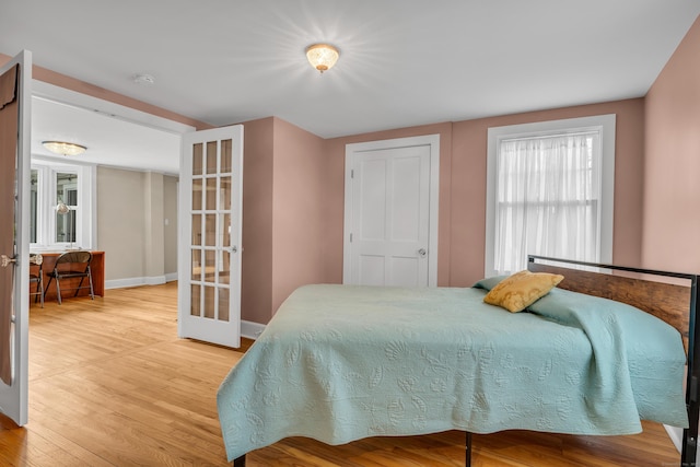 387 N River St, Guilford, CT 06437 - bedroom featuring french doors, wood finished floors, and baseboards