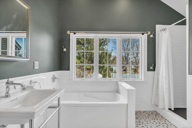 387 N River St, Guilford, CT 06437 - bathroom featuring tiled shower, a garden tub, wainscoting, tile walls, and a sink