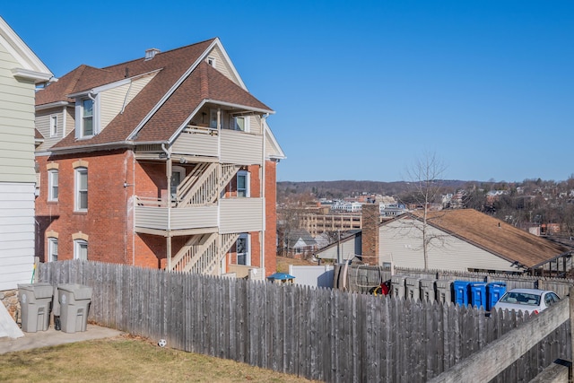 45 Willis St, Bristol, CT 06010 - exterior space with brick siding, roof with shingles, a balcony, and fence