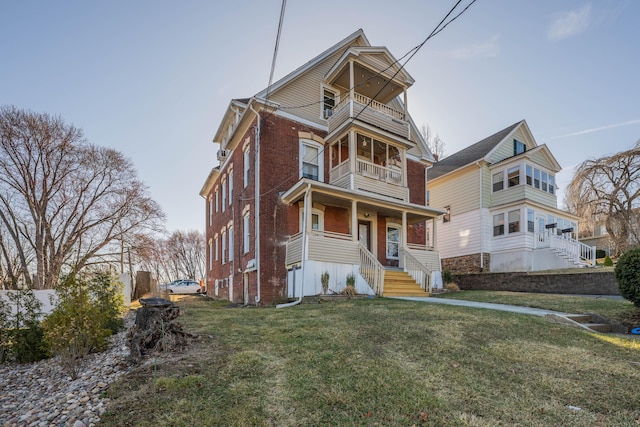 45 Willis St, Bristol, CT 06010 - view of front of home with brick siding, a front lawn, and a balcony