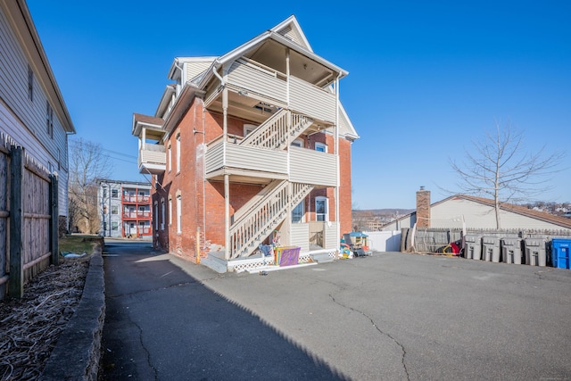 45 Willis St, Bristol, CT 06010 - rear view of property featuring a balcony, fence, and brick siding