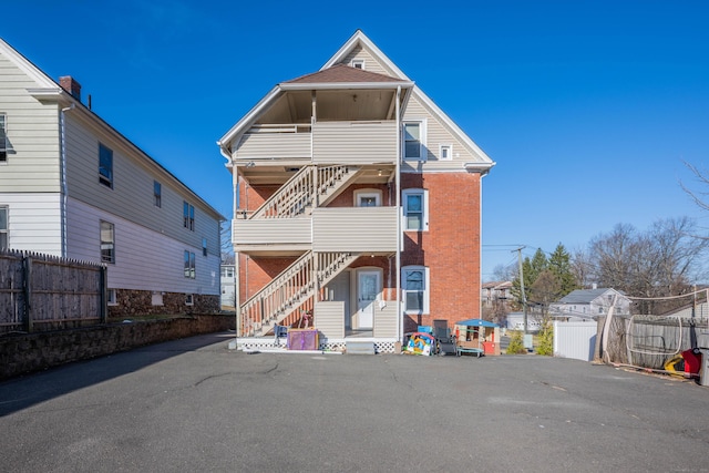 45 Willis St, Bristol, CT 06010 - back of house featuring brick siding, a balcony, and fence