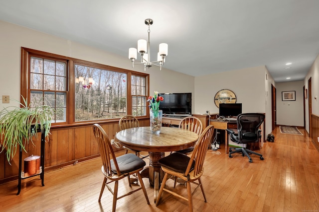 dining space with a chandelier and light wood finished floors