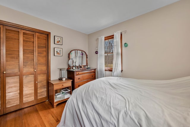 bedroom featuring a closet and light wood-style flooring