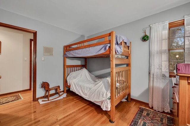 bedroom featuring baseboards and wood finished floors