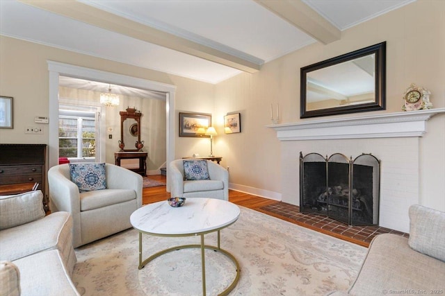 3 Middle Rd, Hamden, CT 06517 - living room featuring beam ceiling, a brick fireplace, wood finished floors, and a chandelier