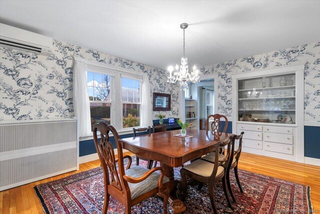 3 Middle Rd, Hamden, CT 06517 - dining area featuring a chandelier, a wall unit AC, and wallpapered walls
