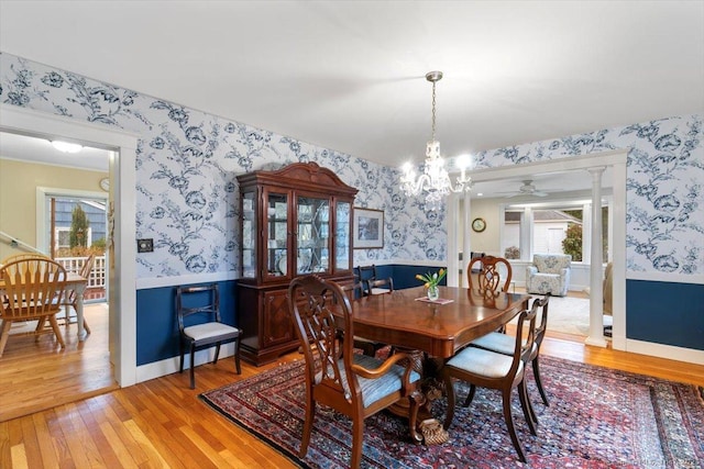 3 Middle Rd, Hamden, CT 06517 - dining space featuring ceiling fan with notable chandelier, a wainscoted wall, light wood finished floors, and wallpapered walls