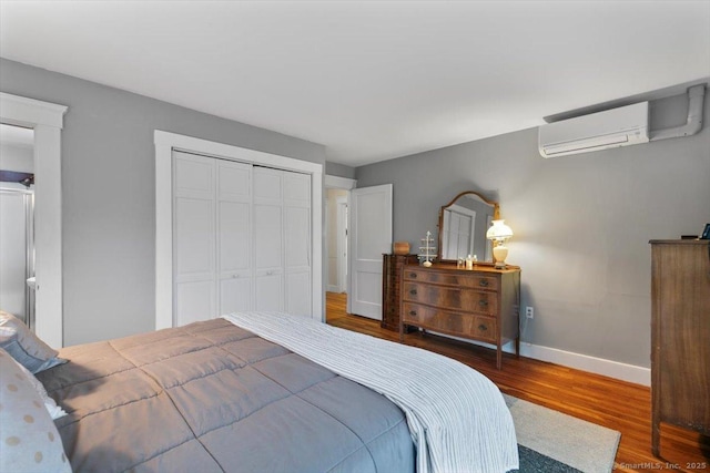 3 Middle Rd, Hamden, CT 06517 - bedroom featuring a wall mounted air conditioner, baseboards, a closet, and wood finished floors
