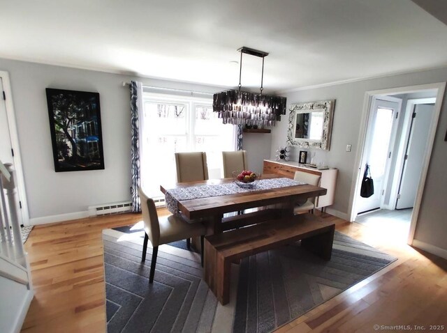 dining space with a wealth of natural light, light wood finished floors, an inviting chandelier, and baseboards