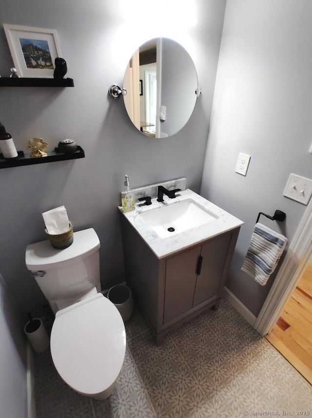 bathroom featuring tile patterned floors, toilet, and vanity