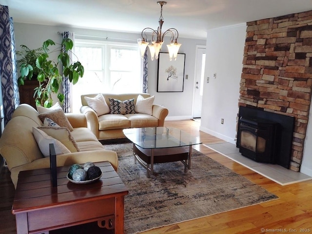 living area with wood finished floors, baseboards, and a notable chandelier