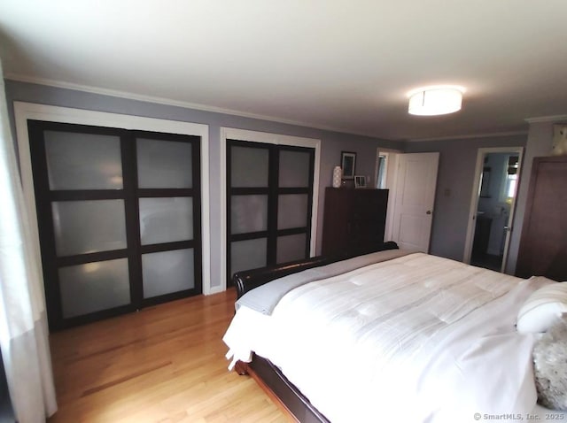 bedroom with light wood finished floors and ornamental molding