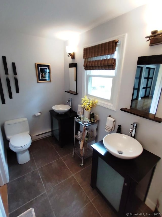 bathroom with toilet, tile patterned floors, a baseboard radiator, and vanity