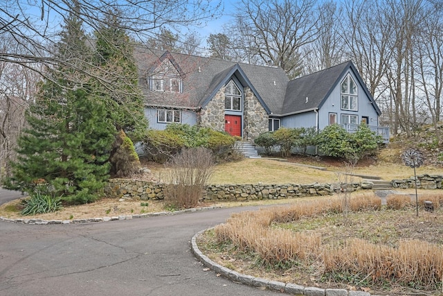 tudor-style house with stone siding