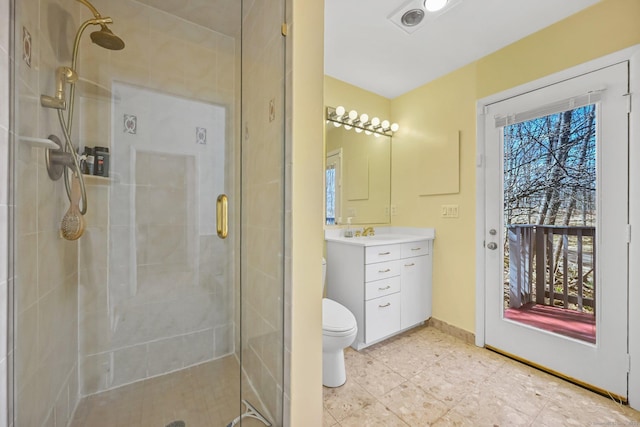 bathroom with vanity, tile patterned flooring, a stall shower, and toilet
