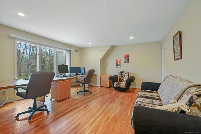 office space featuring light wood-style floors, recessed lighting, baseboards, and visible vents