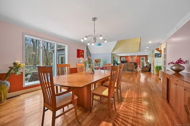 dining space with ornamental molding, light wood finished floors, and a wealth of natural light