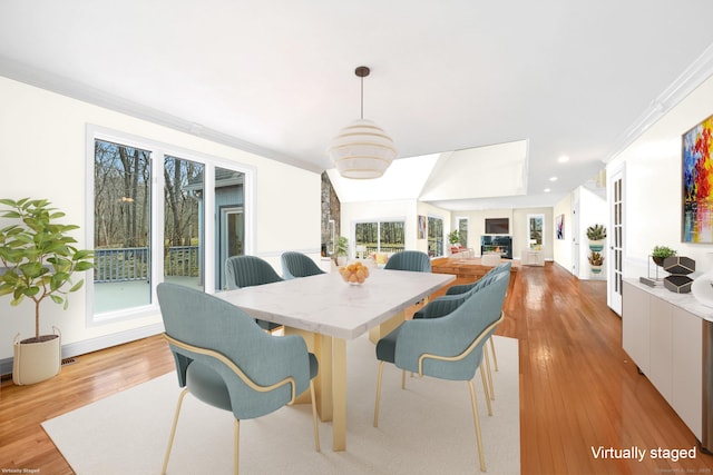 dining space featuring recessed lighting, a healthy amount of sunlight, and light wood-style floors