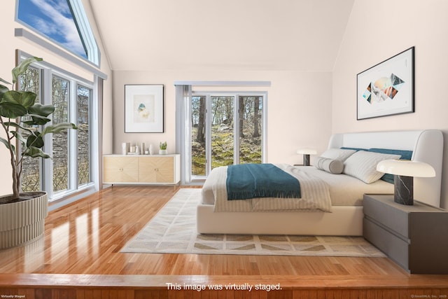 bedroom featuring wood finished floors and lofted ceiling