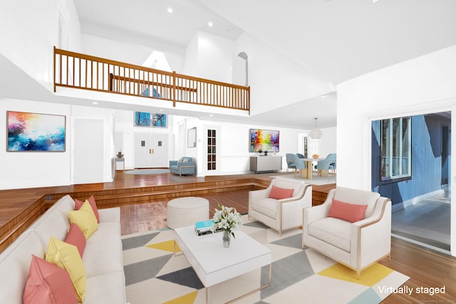 living room featuring recessed lighting, high vaulted ceiling, and wood finished floors