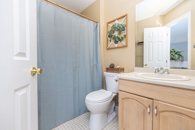 bathroom featuring toilet, vanity, tile patterned floors, and a shower with shower curtain