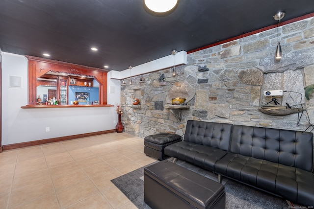 living room featuring tile patterned floors, indoor bar, baseboards, and recessed lighting