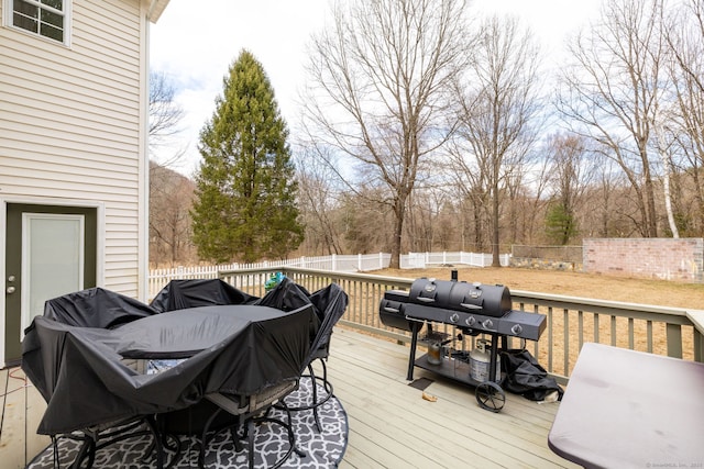 wooden terrace featuring a fenced backyard and grilling area