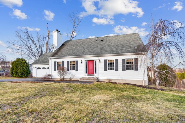 view of front of house with aphalt driveway, an attached garage, a chimney, and a front yard