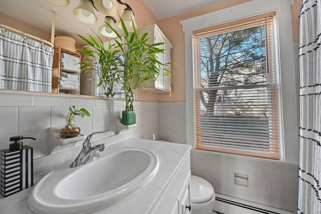 14 Overlook Pl, Stamford, CT 06907 - full bath with vanity, wainscoting, a baseboard heating unit, tile walls, and toilet
