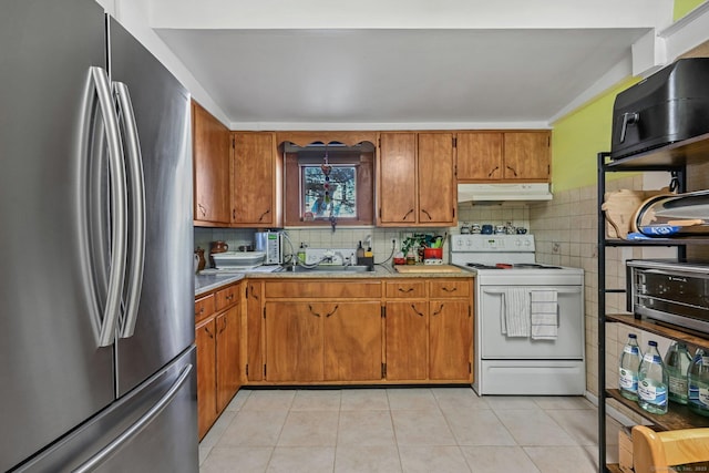 14 Overlook Pl, Stamford, CT 06907 - kitchen featuring electric range, brown cabinets, under cabinet range hood, a sink, and freestanding refrigerator