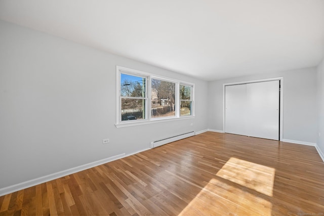 14 Overlook Pl, Stamford, CT 06907 - unfurnished bedroom featuring wood finished floors, a closet, baseboard heating, and baseboards