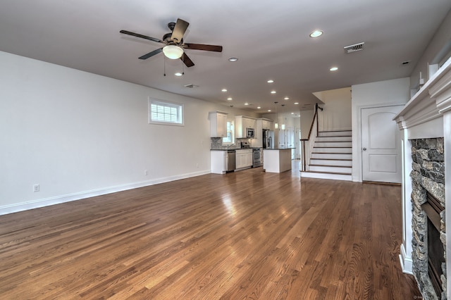 36 Deerfield Ave, Milford, CT 06460 - unfurnished living room featuring a fireplace, a ceiling fan, recessed lighting, dark wood-type flooring, and stairway