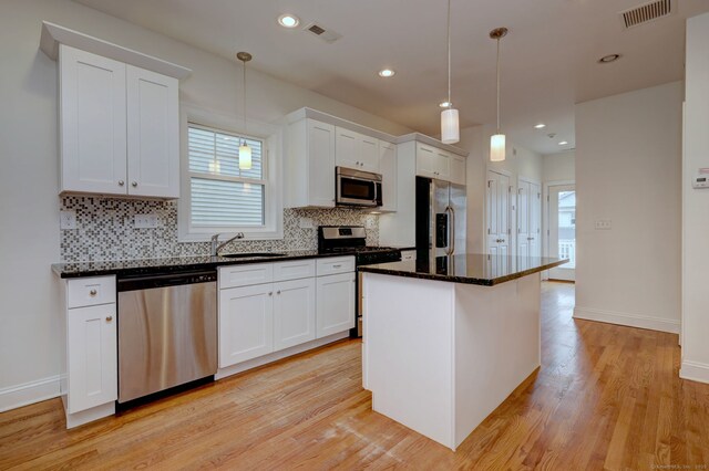 36 Deerfield Ave, Milford, CT 06460 - kitchen with visible vents, a sink, backsplash, and stainless steel appliances
