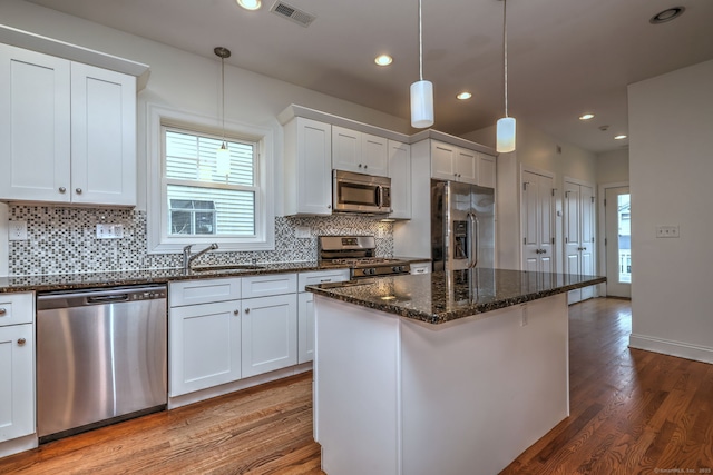 36 Deerfield Ave, Milford, CT 06460 - kitchen with a sink, stainless steel appliances, wood finished floors, backsplash, and visible vents