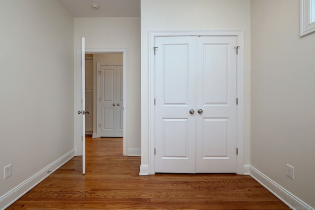 36 Deerfield Ave, Milford, CT 06460 - unfurnished bedroom with baseboards, light wood finished floors, and a closet