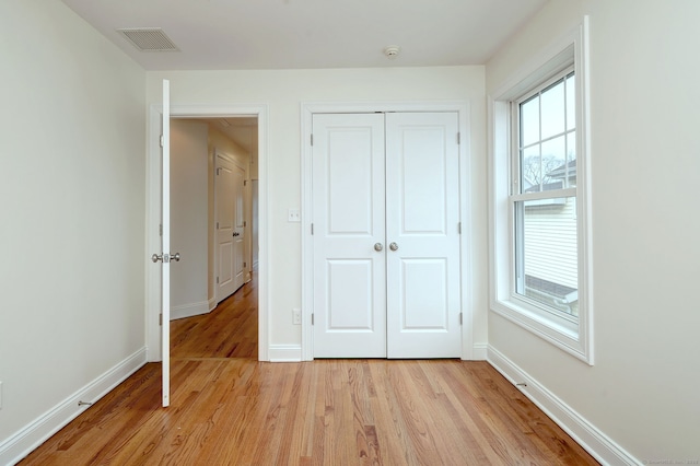 36 Deerfield Ave, Milford, CT 06460 - unfurnished bedroom with light wood-style floors, baseboards, and a closet