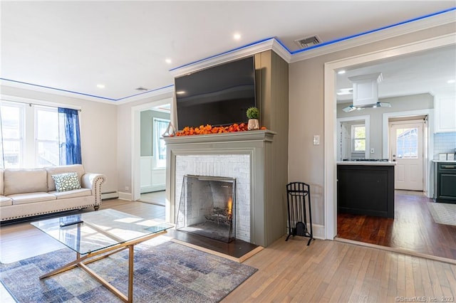 18 Fenway St, Stamford, CT 06902 - living area with light wood-type flooring, visible vents, recessed lighting, a fireplace, and crown molding