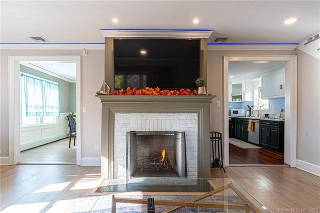 18 Fenway St, Stamford, CT 06902 - details with dishwasher, crown molding, wood finished floors, and white microwave