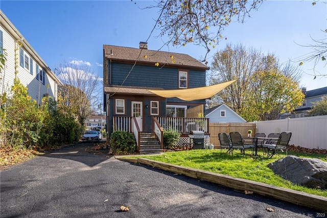 18 Fenway St, Stamford, CT 06902 - rear view of property with a yard, fence, and a chimney