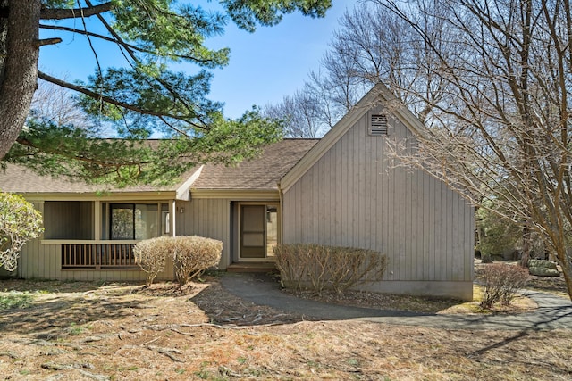 view of front facade with roof with shingles