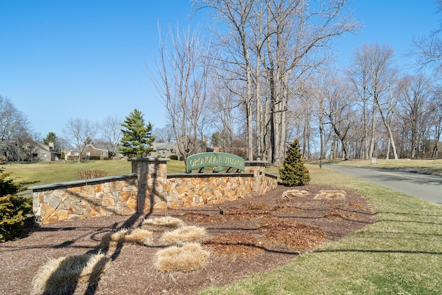 community / neighborhood sign with a lawn