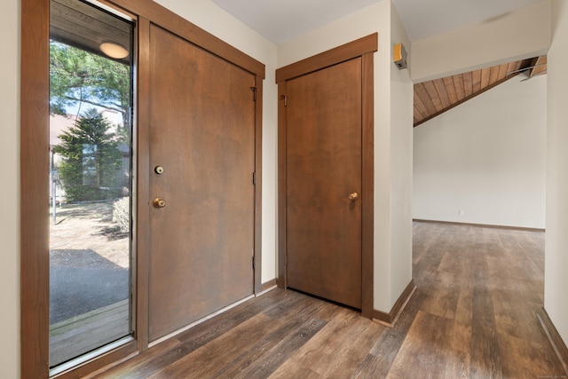 foyer entrance featuring wood ceiling, baseboards, lofted ceiling, and dark wood finished floors